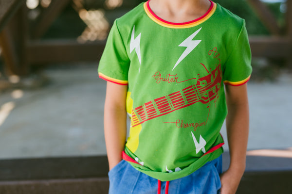 Air Guitar Champ Baby T-Shirt by: Mini Shatsu